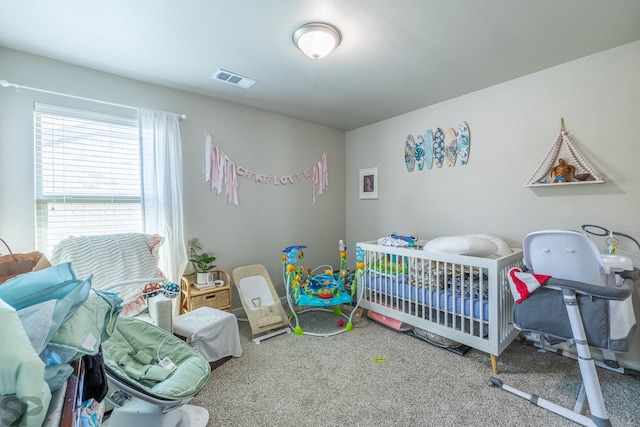 carpeted bedroom with a nursery area