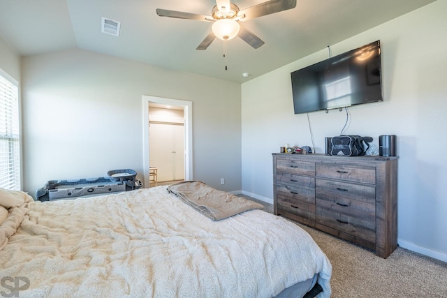 bedroom with vaulted ceiling, light colored carpet, and ceiling fan