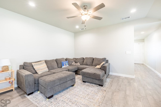 living room with vaulted ceiling, light hardwood / wood-style floors, and ceiling fan