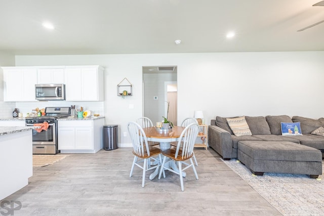 dining room with light hardwood / wood-style flooring