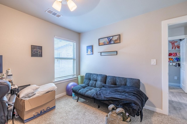 living room featuring plenty of natural light, ceiling fan, and carpet flooring