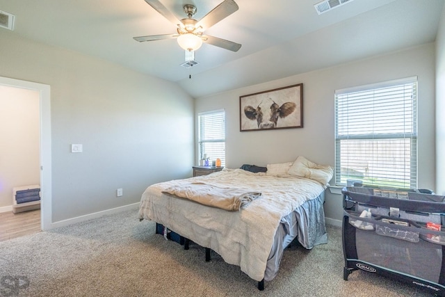 carpeted bedroom with ceiling fan and lofted ceiling