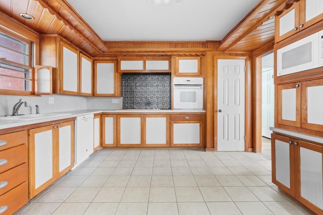 kitchen featuring sink, white appliances, and light tile patterned floors