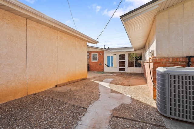 exterior space with cooling unit and a patio area