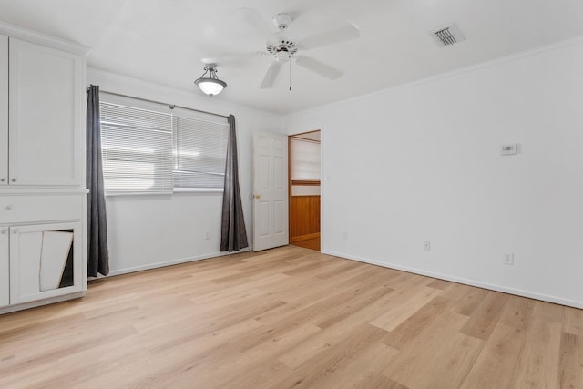 unfurnished bedroom featuring ceiling fan, ornamental molding, and light wood-type flooring