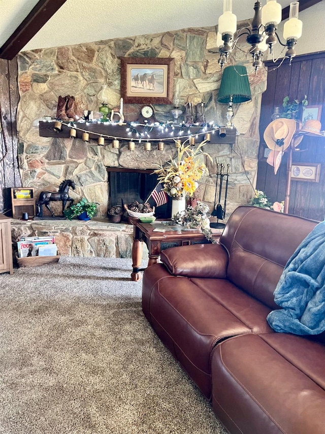 living room with a fireplace, carpet floors, beamed ceiling, and a textured ceiling