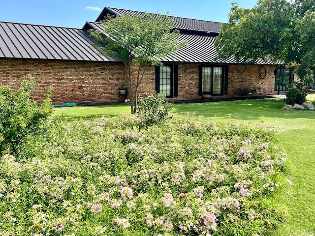 back of property featuring a lawn