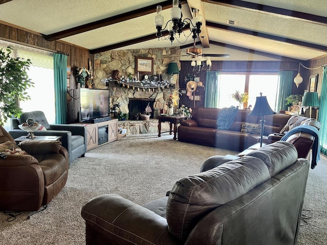 living room with an inviting chandelier, carpet, lofted ceiling with beams, a textured ceiling, and a stone fireplace