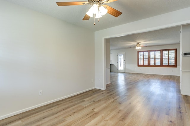 spare room featuring ceiling fan, a textured ceiling, and light hardwood / wood-style flooring