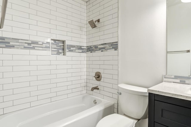 full bathroom with vanity, tiled shower / bath combo, and toilet