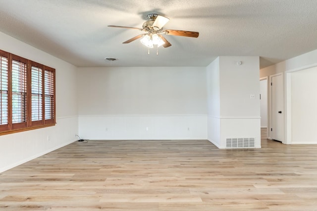 unfurnished room with ceiling fan, a textured ceiling, and light hardwood / wood-style floors