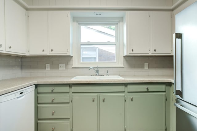 kitchen with dishwasher, sink, high end refrigerator, white cabinets, and decorative backsplash