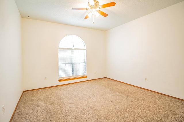 unfurnished room featuring ceiling fan, a textured ceiling, baseboards, and carpet flooring