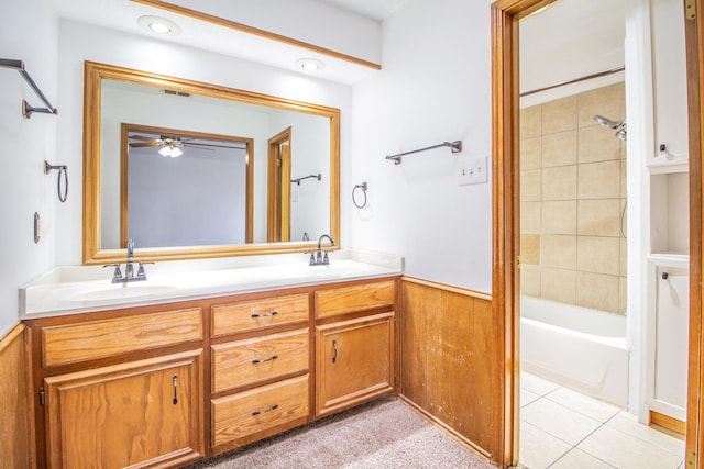 full bathroom with a wainscoted wall, a sink, visible vents, tile patterned floors, and double vanity