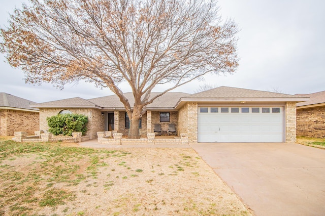 ranch-style home featuring brick siding, driveway, and an attached garage