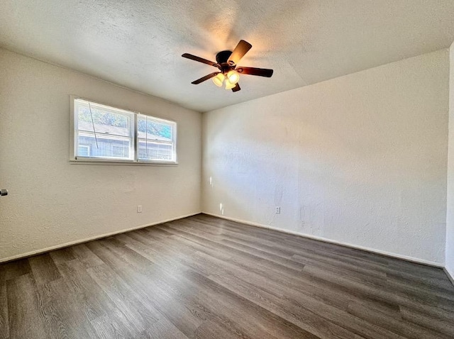 unfurnished room featuring dark hardwood / wood-style flooring, ceiling fan, and a textured ceiling