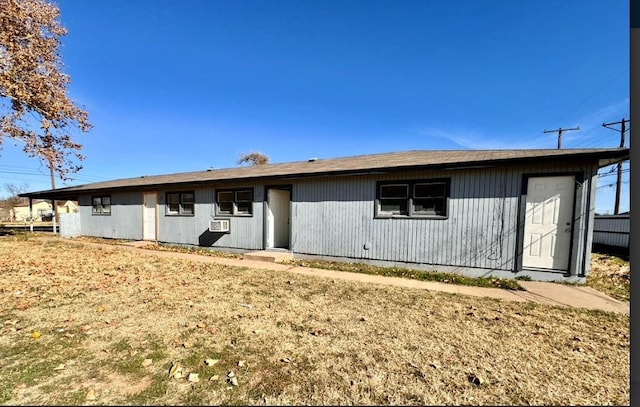 back of property featuring a lawn