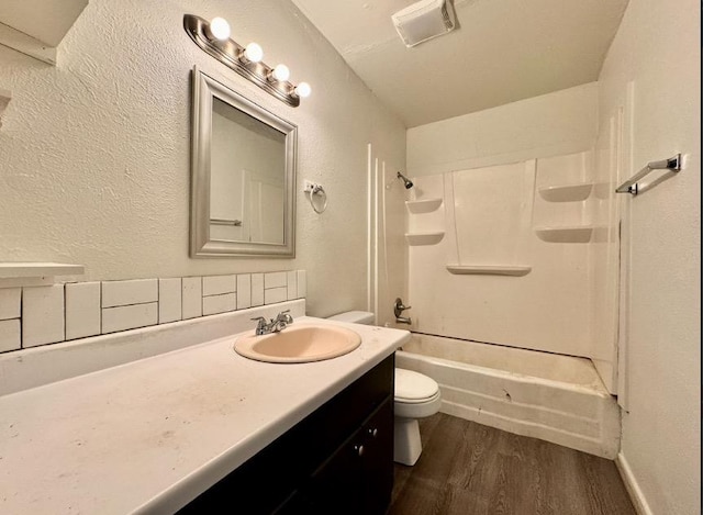 full bathroom with vanity, hardwood / wood-style flooring, toilet, and shower / bath combination