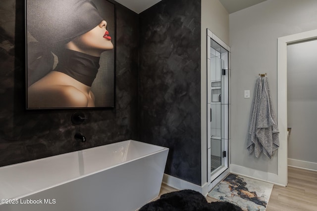 10907 Vicksburg Ave, Lubbock, TX 79424 - full bath featuring wood finished floors, a soaking tub, baseboards, and a shower stall