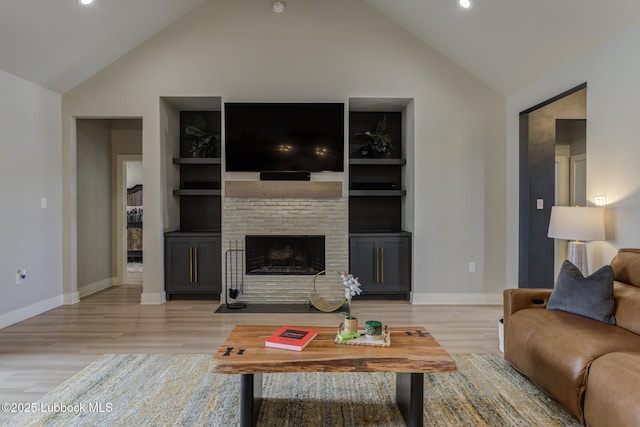 10907 Vicksburg Ave, Lubbock, TX 79424 - living room with light wood-style floors, baseboards, recessed lighting, a fireplace, and high vaulted ceiling
