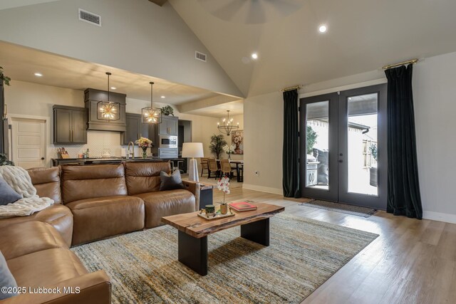 10907 Vicksburg Ave, Lubbock, TX 79424 - living room with baseboards, a chandelier, light wood-style floors, recessed lighting, and high vaulted ceiling