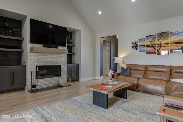 10907 Vicksburg Ave, Lubbock, TX 79424 - living room with light wood-style floors, a fireplace, baseboards, high vaulted ceiling, and recessed lighting