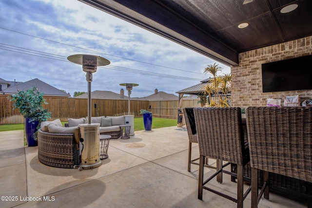 10907 Vicksburg Ave, Lubbock, TX 79424 - fenced backyard featuring an outdoor hangout area, a patio, and a gazebo