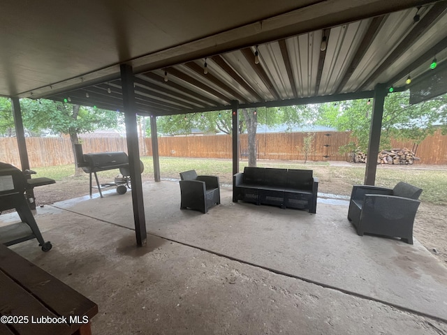 306 Parkwood Ln, Levelland, TX 79336 - fenced backyard featuring a patio area and outdoor lounge area