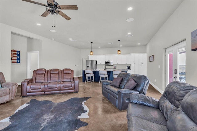 living area with recessed lighting, baseboards, concrete floors, and ceiling fan