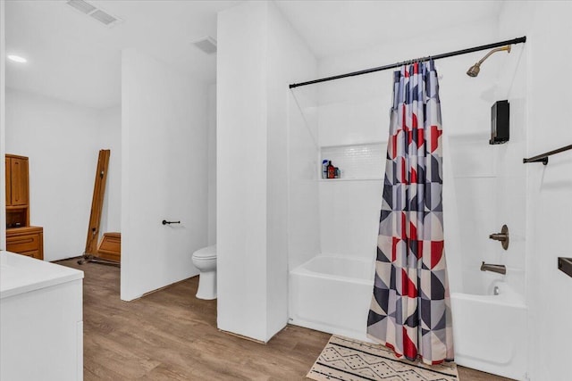 full bath featuring visible vents, toilet, wood finished floors, and shower / tub combo