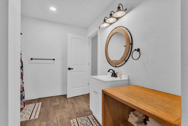 full bath featuring vanity and wood finished floors