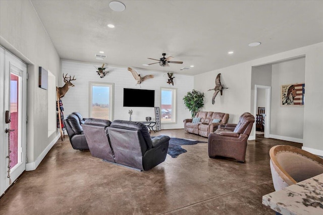 living area with a ceiling fan, visible vents, finished concrete flooring, baseboards, and recessed lighting
