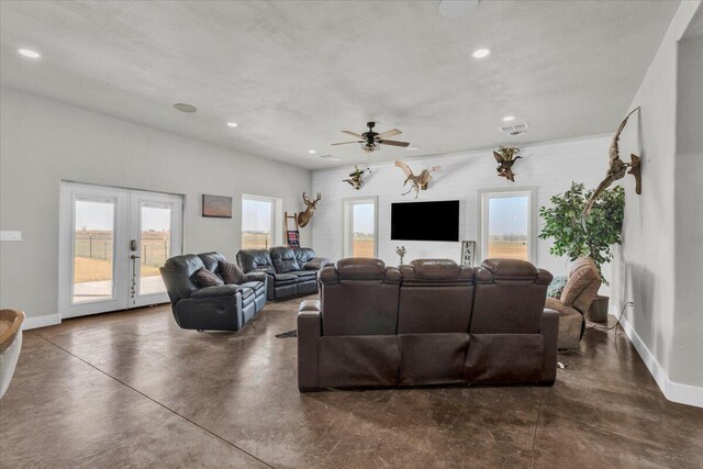 living room with visible vents, a ceiling fan, french doors, concrete floors, and baseboards