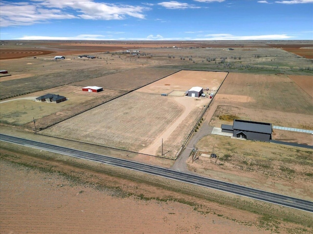 birds eye view of property featuring a rural view