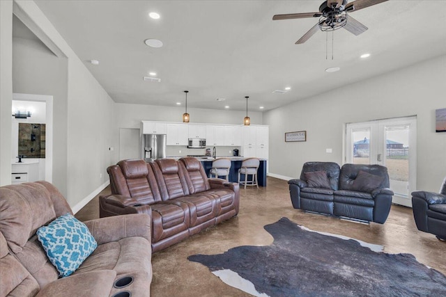 living room with baseboards, recessed lighting, finished concrete floors, ceiling fan, and french doors