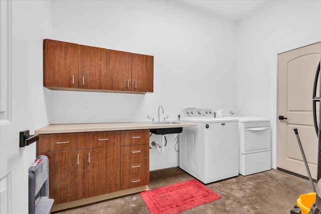 laundry area featuring a sink, cabinet space, and washing machine and dryer
