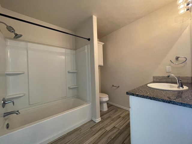 full bathroom with vanity, hardwood / wood-style floors, shower / bathtub combination, and toilet