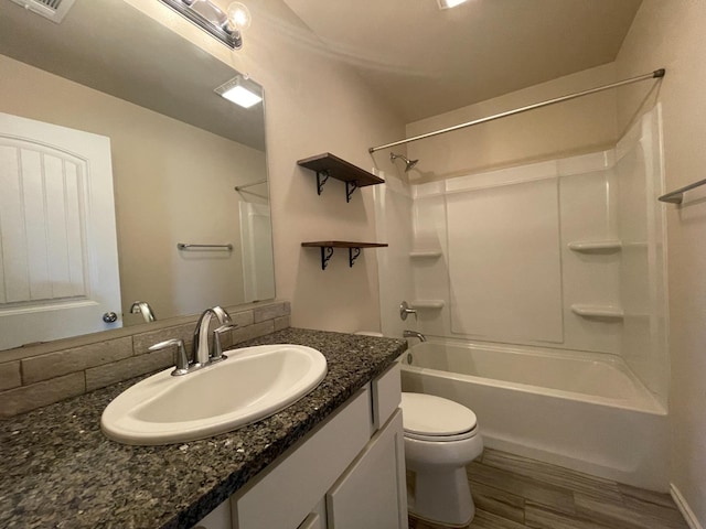 full bathroom featuring vanity, hardwood / wood-style flooring, tub / shower combination, and toilet