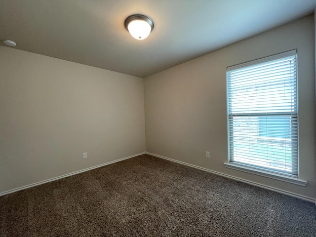 carpeted empty room with plenty of natural light