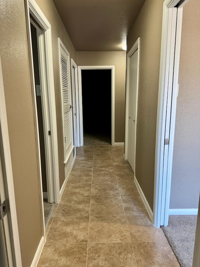 corridor with light tile patterned floors