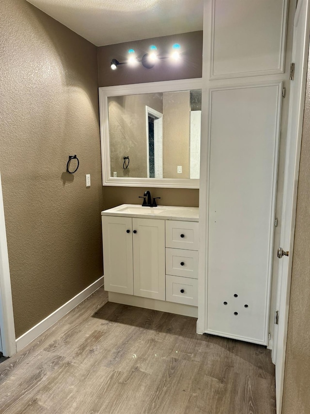 bathroom with wood-type flooring and vanity