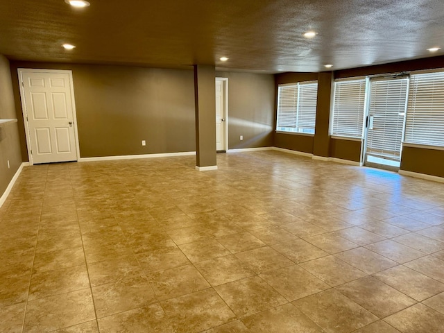 unfurnished room featuring a textured ceiling