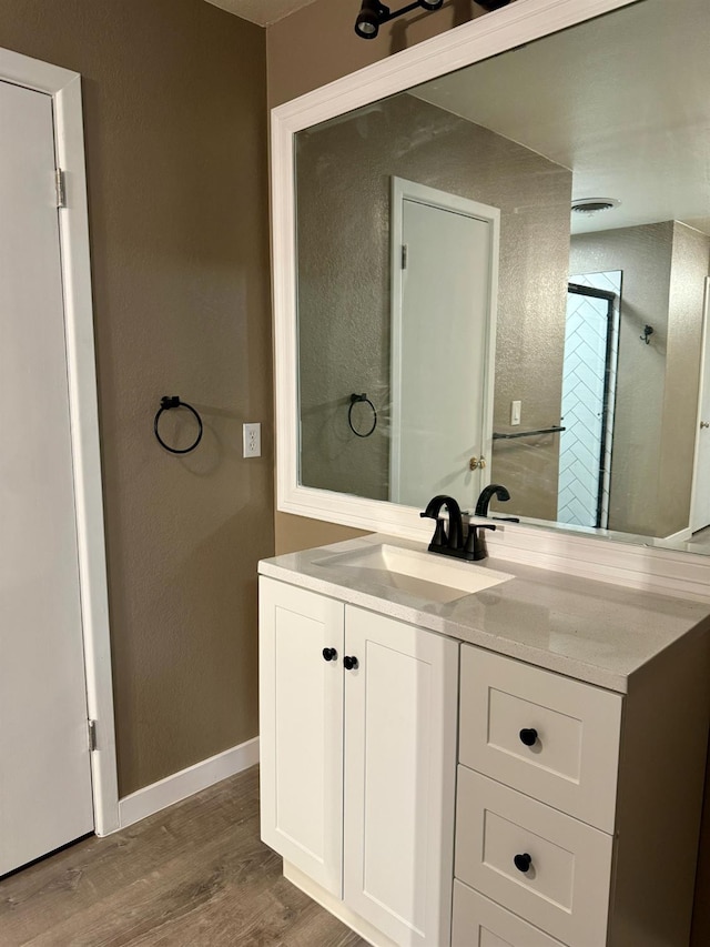 bathroom with vanity and hardwood / wood-style floors