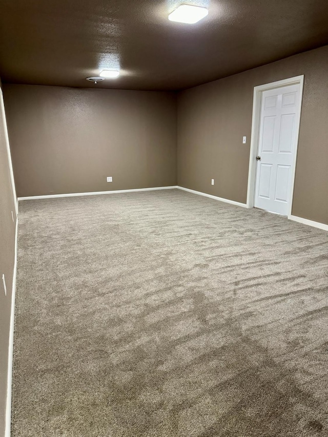 spare room with carpet floors and a textured ceiling