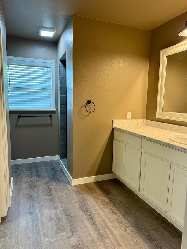 bathroom featuring vanity, hardwood / wood-style flooring, and walk in shower