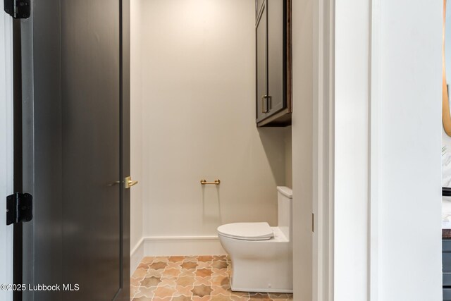 4510 Zadar Ave, Lubbock, TX 79407 - bathroom featuring toilet and baseboards
