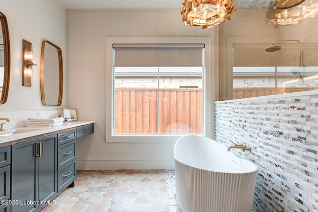 4510 Zadar Ave, Lubbock, TX 79407 - bathroom featuring vanity, a freestanding bath, a tile shower, and a chandelier
