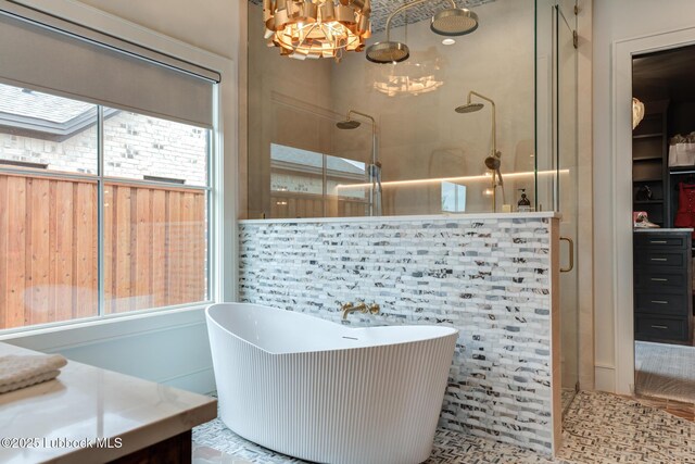 4510 Zadar Ave, Lubbock, TX 79407 - full bath with a stall shower, a freestanding bath, and a chandelier