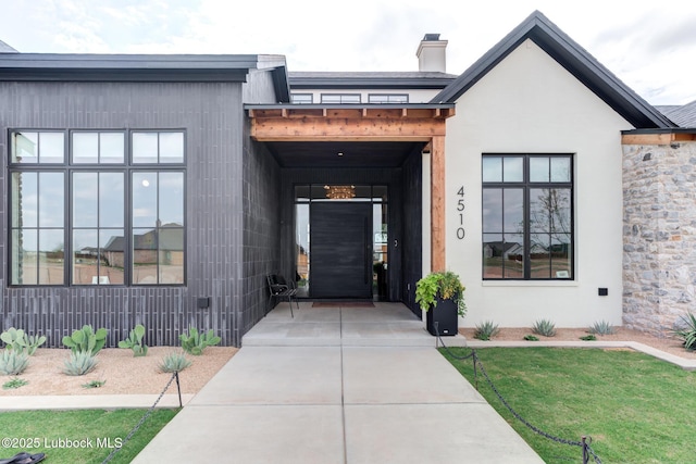 4510 Zadar Ave, Lubbock, TX 79407 - doorway to property featuring stucco siding and a chimney