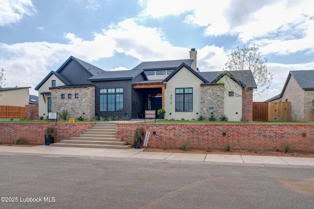 4510 Zadar Ave, Lubbock, TX 79407 - view of front of house with stone siding, stucco siding, and a chimney